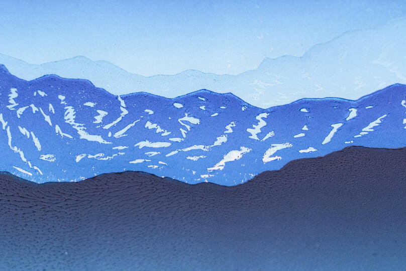 A 4-step reduction blockprint of a mountain vista.