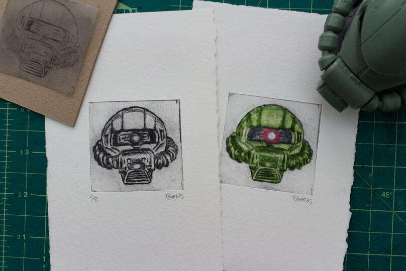 Drypoint etching and watercolor prints of a Zaku head.